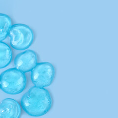 Thick blue gel drops with bubbles, copy space, 1:1.