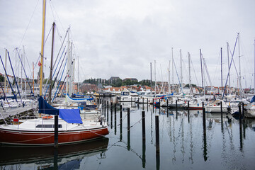 Fototapeta premium Scenic view of Flensburg harbor with sailboats moored on calm water