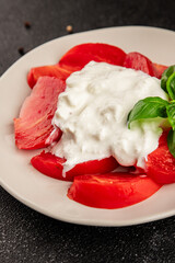 Salad strachatella and tomato portion size natural product tasty snack fresh delicious gourmet food background on the table rustic top view copy space keto and paleo diet