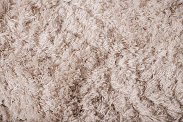 Fluffy rug surface, neutral fabric texture for design.