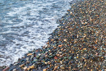 Close up shot of the pebbles of the beach. Background