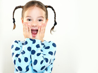 The child is a beautiful girl with wide eyes, look away in surprise. Baby in a knitted sweatshirt ....