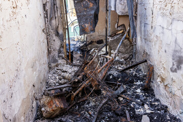 War. The aftermath of Russian airstrikes on a peaceful Ukrainian city. A hospital and a recreation center were destroyed. Charred corridor with collapsed ceiling, soot blackened walls.