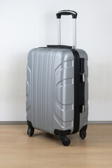 Experience the convenience and style of a fashionable silver hardshell luggage on wheels