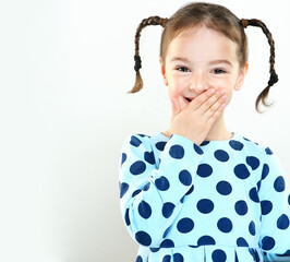 The child is a beautiful girl with wide eyes, look away in surprise. Baby in a knitted sweatshirt ....