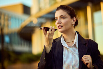 Confident Business Woman Talks On Phone Outdoors Near Modern Office Building For Stock Photo Use