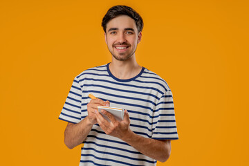 Handsome Young Man Writing Notes Planner, Pen.student Writes Plans, To-Do List