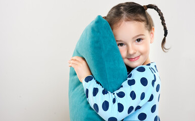 The child is a beautiful girl with wide eyes, look away in surprise. Baby in a knitted sweatshirt ....