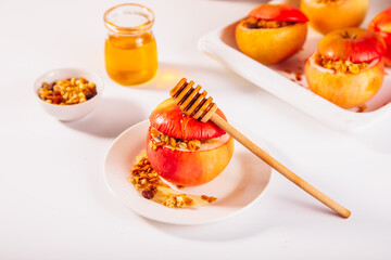 Sweet autumn dessert baked apples stuffed with muesli, nuts and honey.