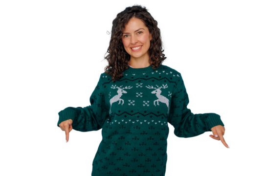Happy woman wearing christmas sweater smiling and pointing down, celebrating holiday season, transparent background