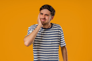 Young Man Touching Cheek With Painful Expression, Reacting To Sudden Toothache