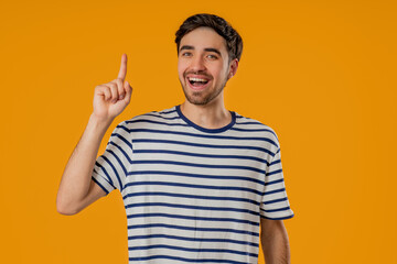 Genius Idea. Resourceful 20S Aged man has eureka Moment, Pointing Finger Up