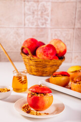Sweet autumn dessert baked apples stuffed with muesli, nuts and honey.