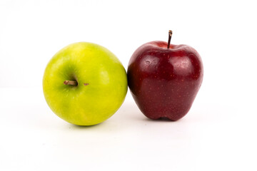 A bright green apple sits next to a deep red apple on a clean white background.