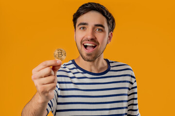 Man With Bitcoin, Crypto Currency. Golden Coin On Yellow Background.