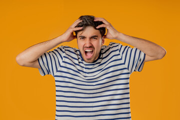Stressed angry man Shouting, Guy In Shock on Yellow. Panicked facial expression