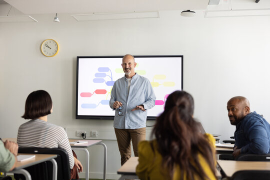 Group of adult students listening to teacher&rsquo;s lecture