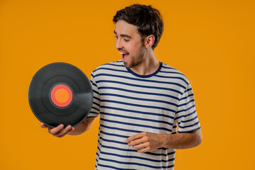 Handsome Man With Vinyl Record Disc On Yellow. Hobby, Music Lover, collection
