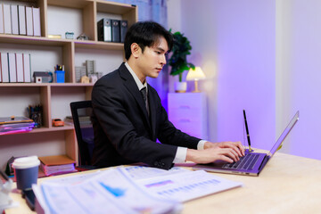 Fototapeta premium Man in formal attire seriously working on business strategies at the computer.