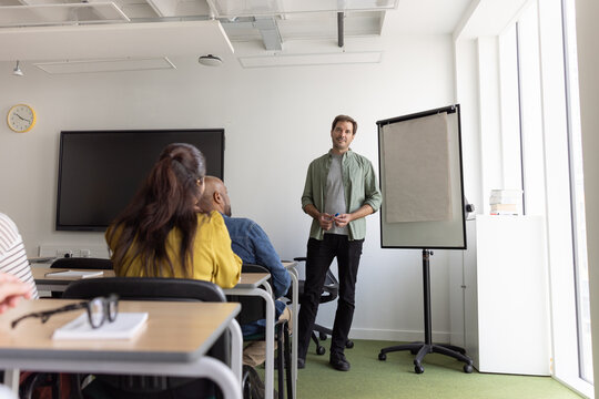 Students in adult education listening to teacher in class