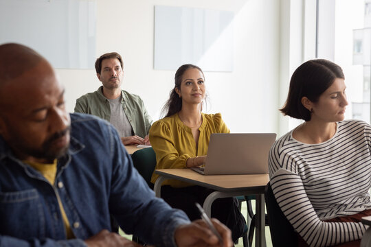 Adult student listening to teacher in a class