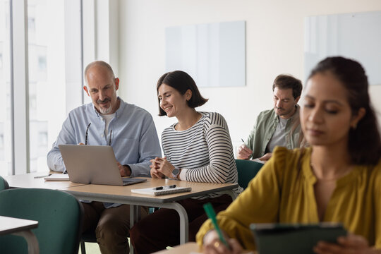 Friendly discussion among students at a desks