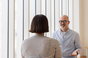 Smiling team member discussing strategies in meeting.