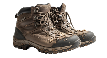 Muddy hiking boots sit on a clean surface after a long trek on a wooded trail during a sunny afternoon in the forest