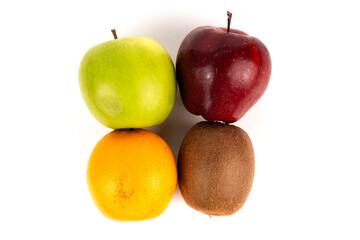 Red and green apple sit atop orange and kiwi showing colorful healthy eating plan.