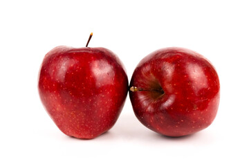 Two ripe, sweet apples display natural red color for nutrition or fresh produce concept.