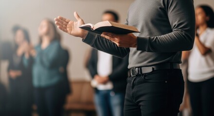Man holding bible and preaching with hand gesture during a Christian church service. Worship and praise.