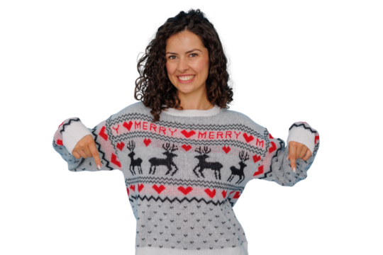 Young woman wearing festive christmas sweater pointing down with both hands, happy for winter holidays, transparent background