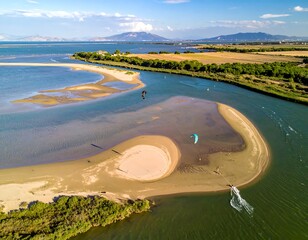 Aerial view of a coastal lagoon with sandbars, shallow water, and kitesurfers