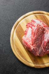 Raw beef meat on a wooden cutting board