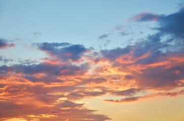 A dramatic sunset sky with a single fiery red cloud.