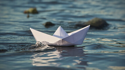 Simple white paper boat glides gracefully across shimmering blue water, symbolizing journeys, dreams, and new beginnings.