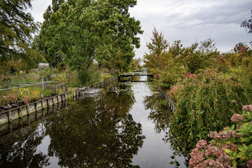 Ditch, bridge and tree nursery in Boskoop with reflection in the water