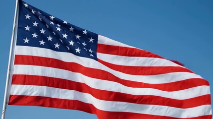 American flag gently waving against clear blue sky, symbol of patriotism and Labor Day holiday.
- Powered by Adobe