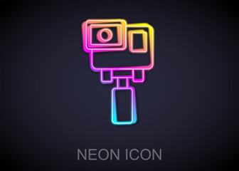 Glowing neon line Action extreme camera icon isolated on black background. Video camera equipment for filming extreme sports. Vector
