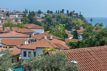 Obraz premium Top view of the tiled roofs of the old town. Kaleici is a quarter in Antalya, located in the Muratpasha district. Historical city center in Antalya. The narrow streets of the old town.