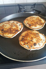 Blueberry pancakes in frying pan. Cooking baking home cooked dough pan cake.