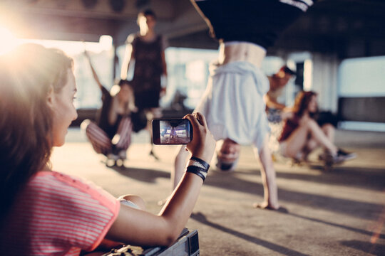 Group of friends enjoying dance and photography - Powered by Adobe