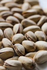 Pistachio nuts close up, on a white background with shallow depth of field. Pistachios, healthy, natural snack.