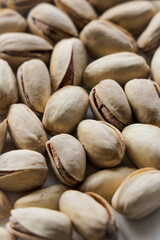 Pistachio nuts group, on a white background with shallow depth of field. Pistachios, healthy, natural snack for on the go.