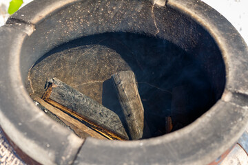 Traditional clay tandoor oven for outdoor cooking, vintage ceramic street stove made of chamotte and decorated with pattern