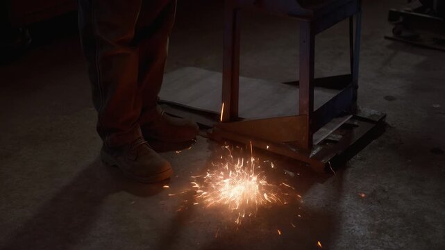 An experienced craftsman works diligently in his workshop, sharpening tools with precision. Sparks fly as he expertly manages the equipment, demonstrating a love for his craft