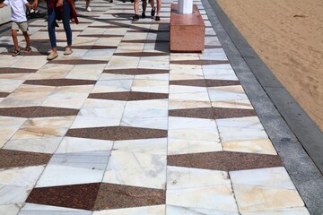 Benidorm city marble flagstone tiled sidewalk pattern on Levante Beach promenade. Benidorm town in Valencian Community (Comunidad Valenciana), Spain.