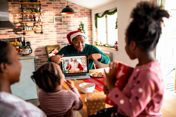 Family celebrating christmas with video call