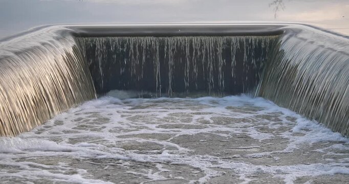 Cascading Water feature: Capturing the mesmerizing movement of a cascading water feature, the image showcases water gracefully flowing over an artificial structure.