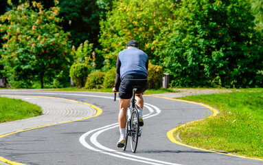Fototapeta premium Cyclist ride on the bike path in the city Park 
